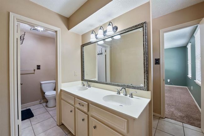 Another private bath with double sinks connects this bedroom to the last bedroom. | Image 28