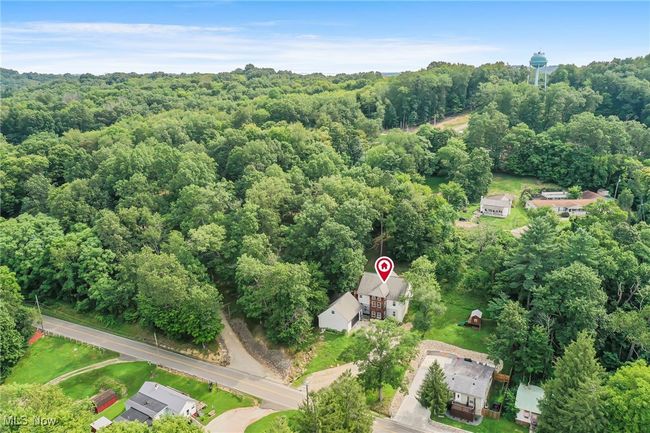 Aerial view of property and surrounding area with a heavily wooded area | Image 50
