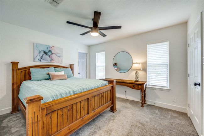 Carpeted bedroom featuring multiple windows, baseboards, and ceiling fan | Image 15