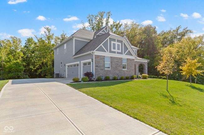 Oversized 3 car side load garage with plenty of space in the driveway and a the turnaround. | Image 6