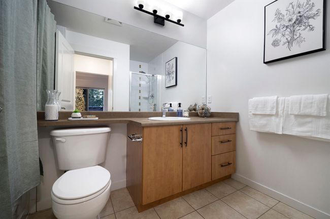 Full bathroom with a shower stall, tile patterned floors, vanity, baseboards, and toilet | Image 18