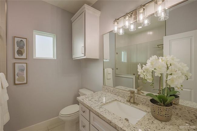 Full bathroom with vanity, a shower with shower door, and tile patterned floors | Image 24