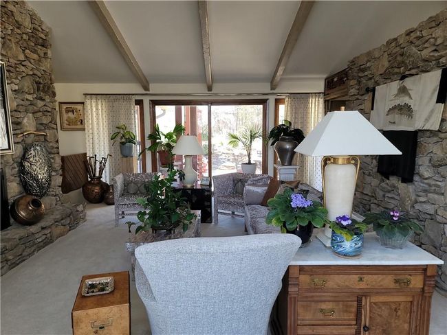 Carpeted living room featuring beam ceiling | Image 6