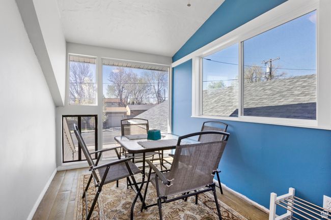 Dining room with wood finished floors, baseboards, and vaulted ceiling | Image 4