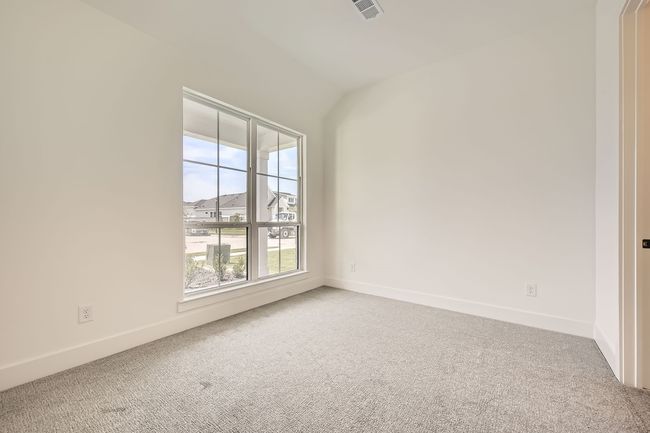 Empty room with carpet flooring, baseboards, and vaulted ceiling | Image 21