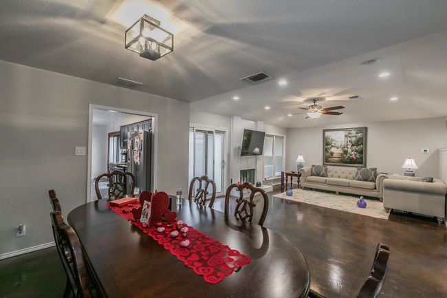 Unit 4904 Dining area with ceiling fan and a large fireplace | Image 28
