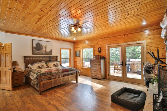 Bedroom featuring access to exterior, hardwood / wood-style flooring, french doors, and wooden ceiling | Image 15