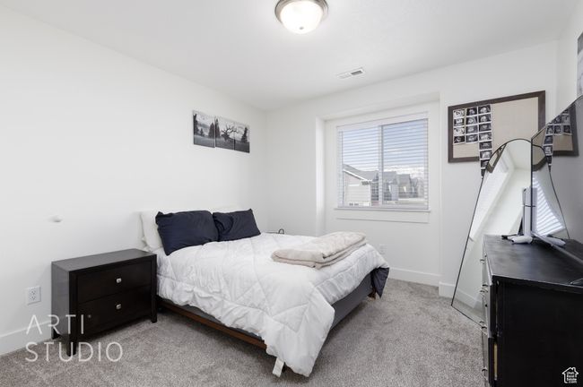 Carpeted bedroom featuring visible vents and baseboards | Image 22