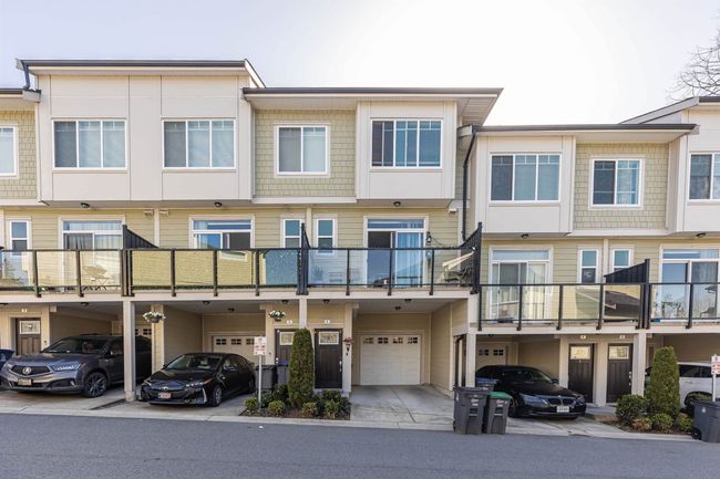 View of property featuring an attached garage and driveway | Image 6
