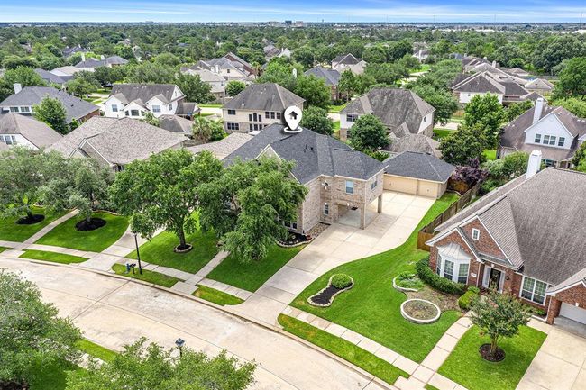 This aerial view shows the expansive driveway with porte-cochere, recent roof and mature trees! | Image 41