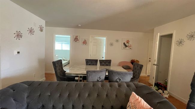 Dining space featuring baseboards and wood finished floors | Image 4