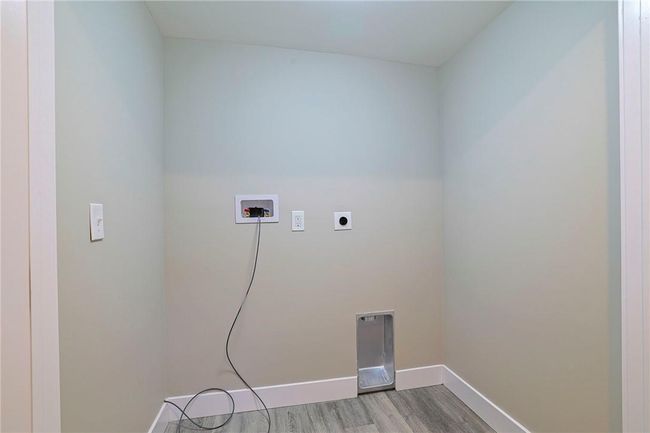 Laundry area with hookup for a washing machine, wood-type flooring, and electric dryer hookup | Image 19