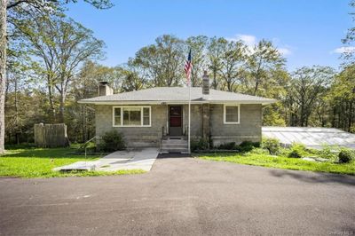 View of the front entrance, newer driveway and attached greenhouse. | Image 2