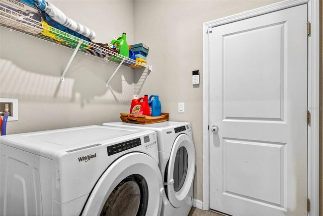 Laundry room leads to the garage. | Image 16