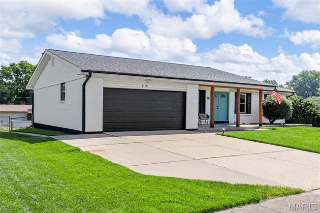 View of front of house featuring an attached garage, driveway, brick siding, a porch, and a shingled roof | Image 35