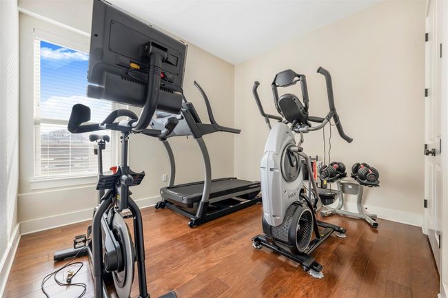 Exercise room featuring wood finished floors and baseboards | Image 8