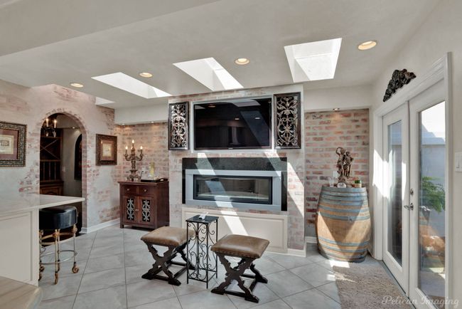 Living area featuring tile patterned flooring, recessed lighting, and a skylight | Image 14