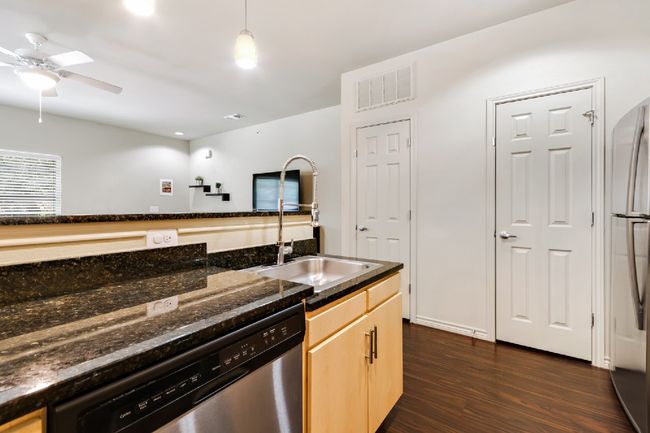 Kitchen featuring dishwasher, freestanding refrigerator, ceiling fan, dark wood-style floors, and light brown cabinets | Image 17