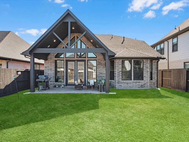 This inviting outdoor space offers a perfect retreat for relaxation and entertaining. sowing the magnificent arquitectural pointed vaulted ceilings of this house an all brick in the back with element of stucco and stone at the front another upgrade on this house! | Image 33