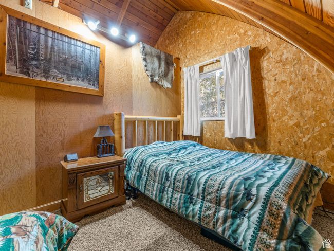 Bedroom with lofted ceiling, wood ceiling, and carpet | Image 17