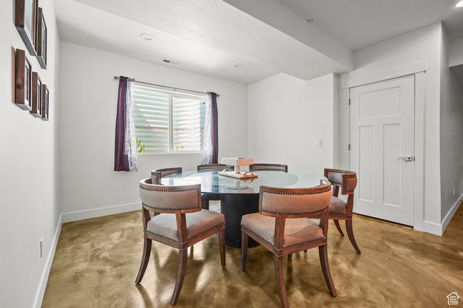 Dining area with finished concrete floors and baseboards | Image 28