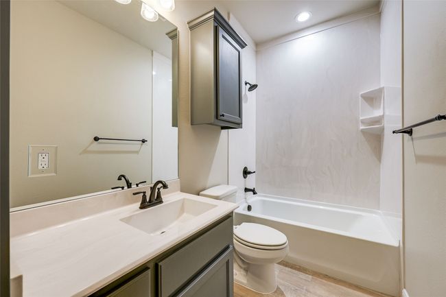 Full bathroom featuring toilet, wood finished floors, vanity, tub / shower combination, and recessed lighting | Image 14