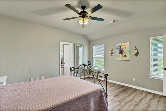 Bedroom with ceiling fan, light hardwood / wood-style flooring, and lofted ceiling | Image 19