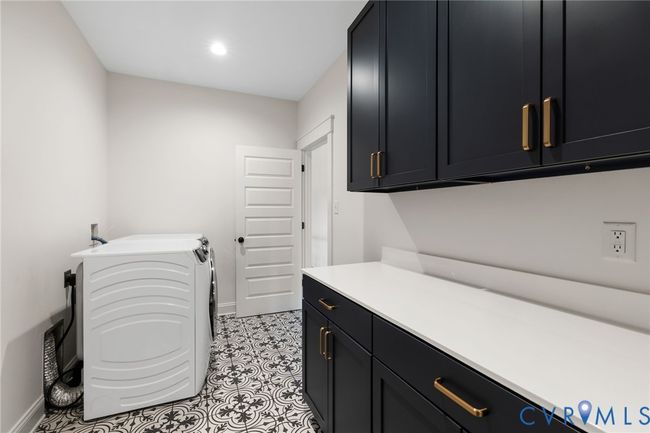 Washroom featuring cabinet space and independent washer and dryer | Image 33