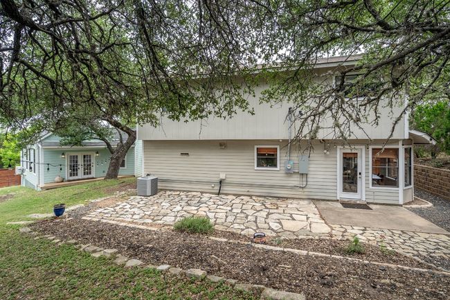 Rear view of property with a patio area made of found materials. | Image 32