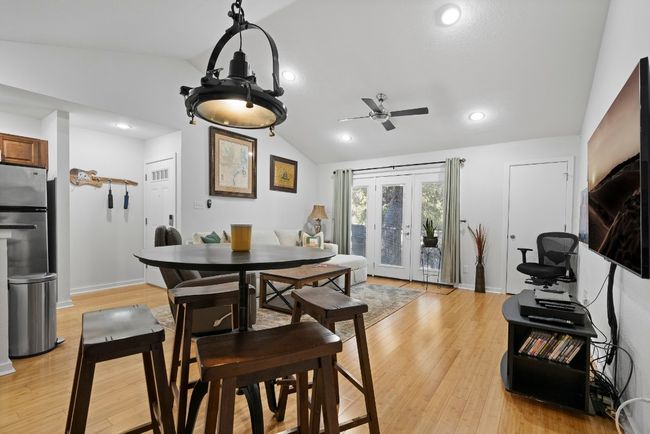 Dining room with vaulted ceiling, a ceiling fan, light wood-style floors, baseboards, and recessed lighting | Image 7
