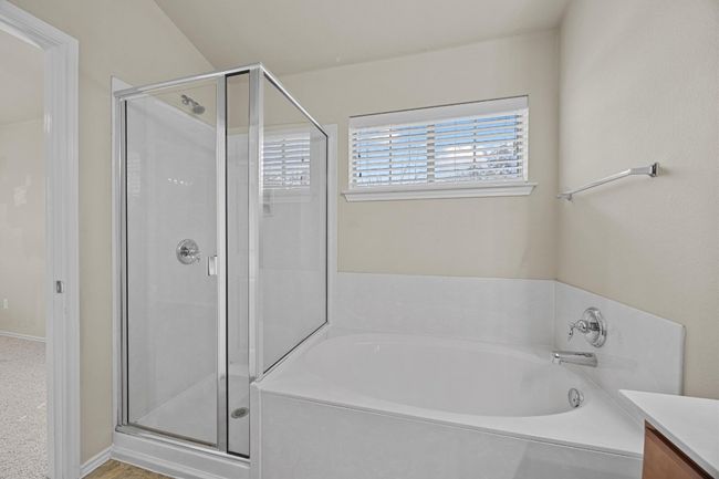 Full bath featuring a garden tub, a shower stall, and vanity | Image 22