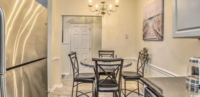 Dining area with a chandelier and light wood-type flooring | Image 14