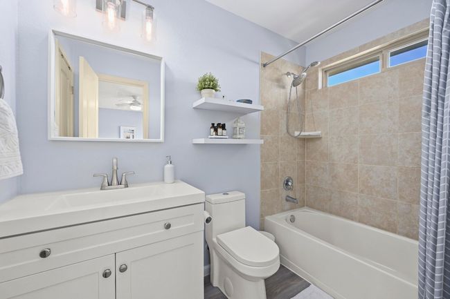 Full bathroom with shower / tub combo, wood finished floors, vanity, and toilet | Image 34
