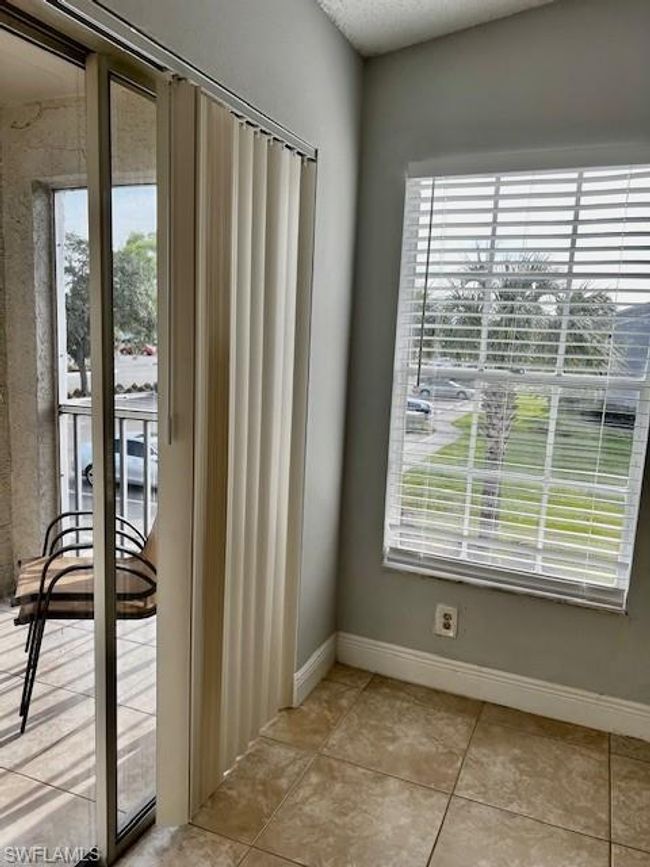 Doorway with light tile patterned flooring and baseboards | Image 6