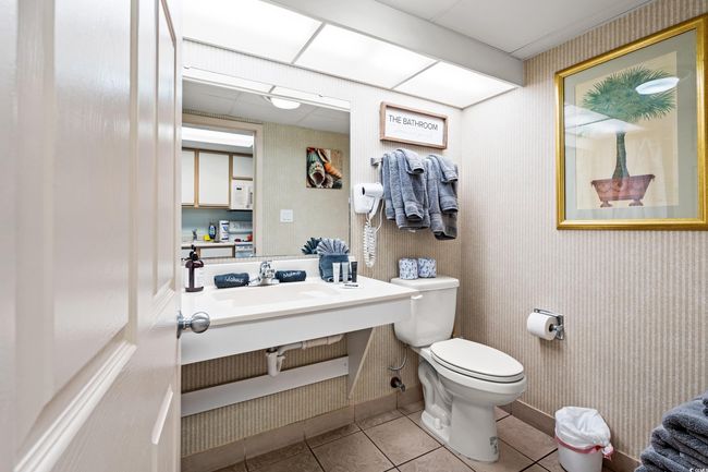 Half bath with a sink and tile patterned floors | Image 11