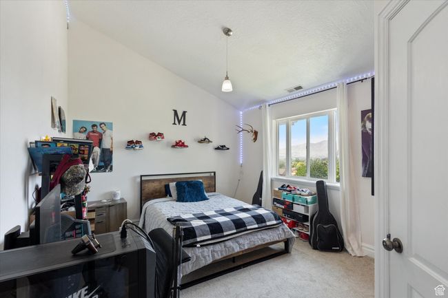 Bedroom with lofted ceiling and private bathroom. | Image 21