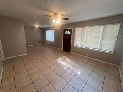 Tiled foyer with a textured ceiling and ceiling fan | Image 3