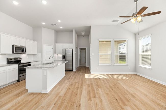 Kitchen featuring appliances with stainless steel finishes, a sink, visible vents, and tasteful backsplash | Image 11
