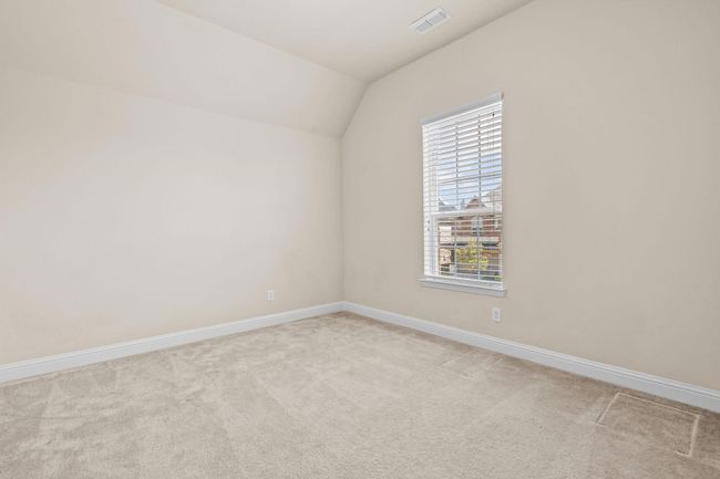 Empty room featuring plenty of natural light, light carpet, baseboards, and vaulted ceiling | Image 24
