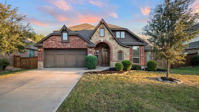 View of front of house featuring a garage and a lawn | Image 1