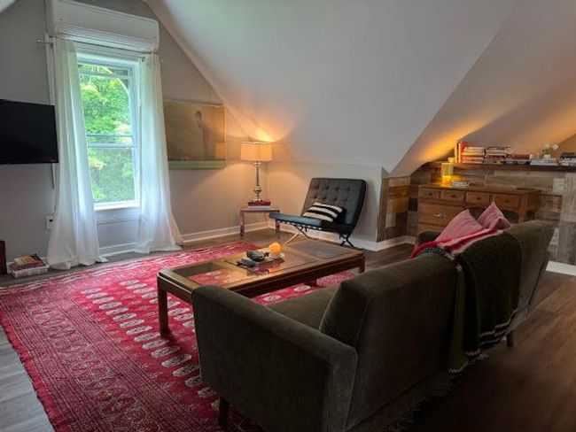 Living area featuring lofted ceiling, plenty of natural light, and wood finished floors | Image 29