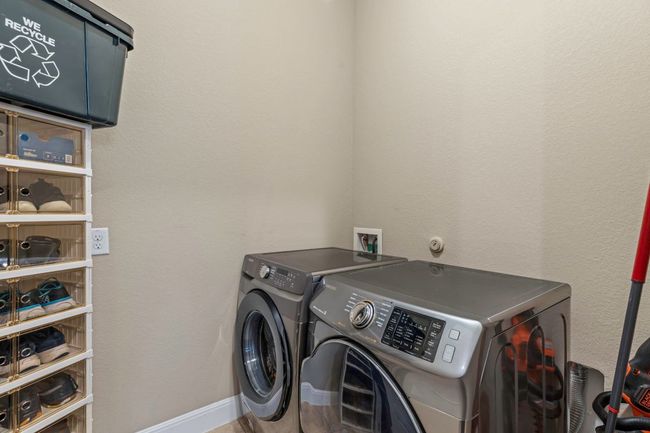 Laundry area featuring washer and clothes dryer and baseboards | Image 23