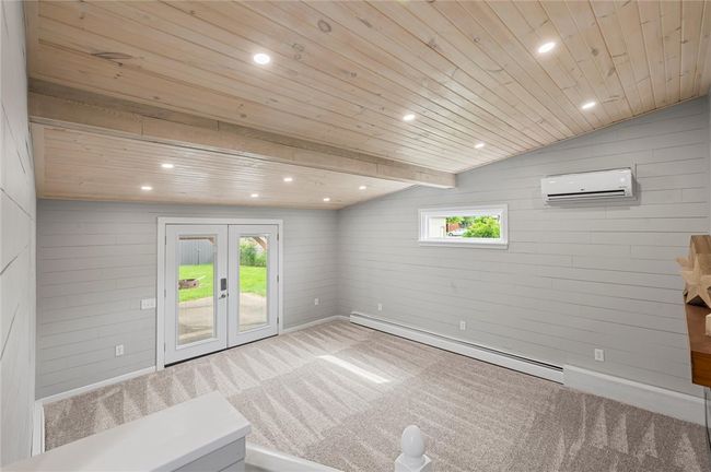 Beautiful family room with French doors leading to the pergola. Cathedral ceilings with shiplap walls. Electric fireplace with mantle. This room has a mini split | Image 13