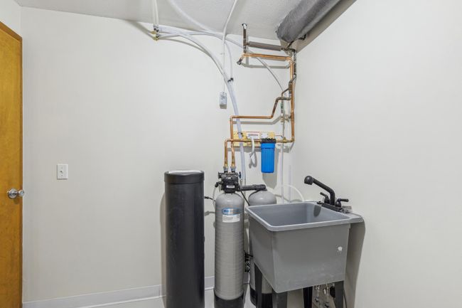 Laundry room with new Kinetico whole house water filtration and softener system. House is on a well. Well water is free water, tested and safe. | Image 18