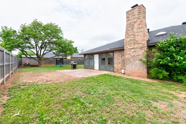 View of yard with a patio, a fenced backyard, a storage unit, and an outdoor structure | Image 27
