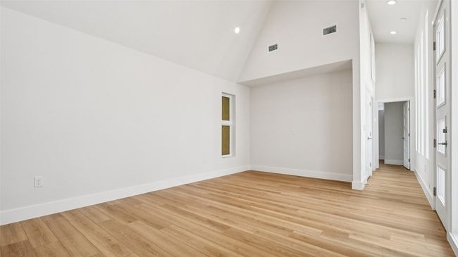 Spare room with high vaulted ceiling, light wood-type flooring, and recessed lighting | Image 6
