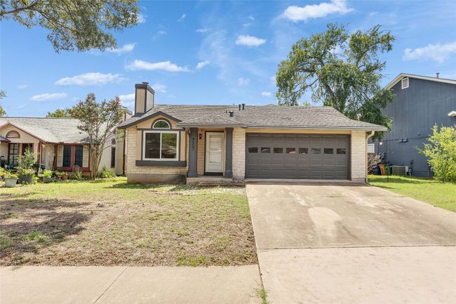 View of front of property featuring brick siding, a front yard, driveway, and an attached garage | Image 24