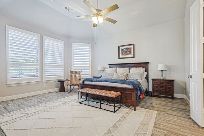 Large Primary Bedroom with sitting area and wall of large windows. | Image 14
