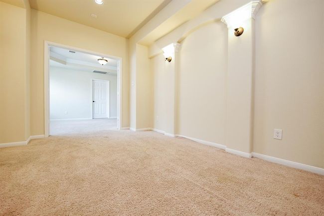 Gorgeous, art-deco-like column detail enhances your rich cinema room, which opens onto common 'game room' space on the 2nd level. | Image 18