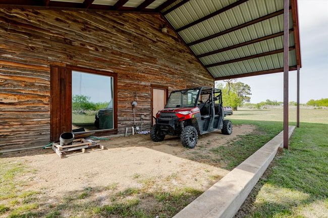 View of parking / parking lot featuring a carport | Image 17